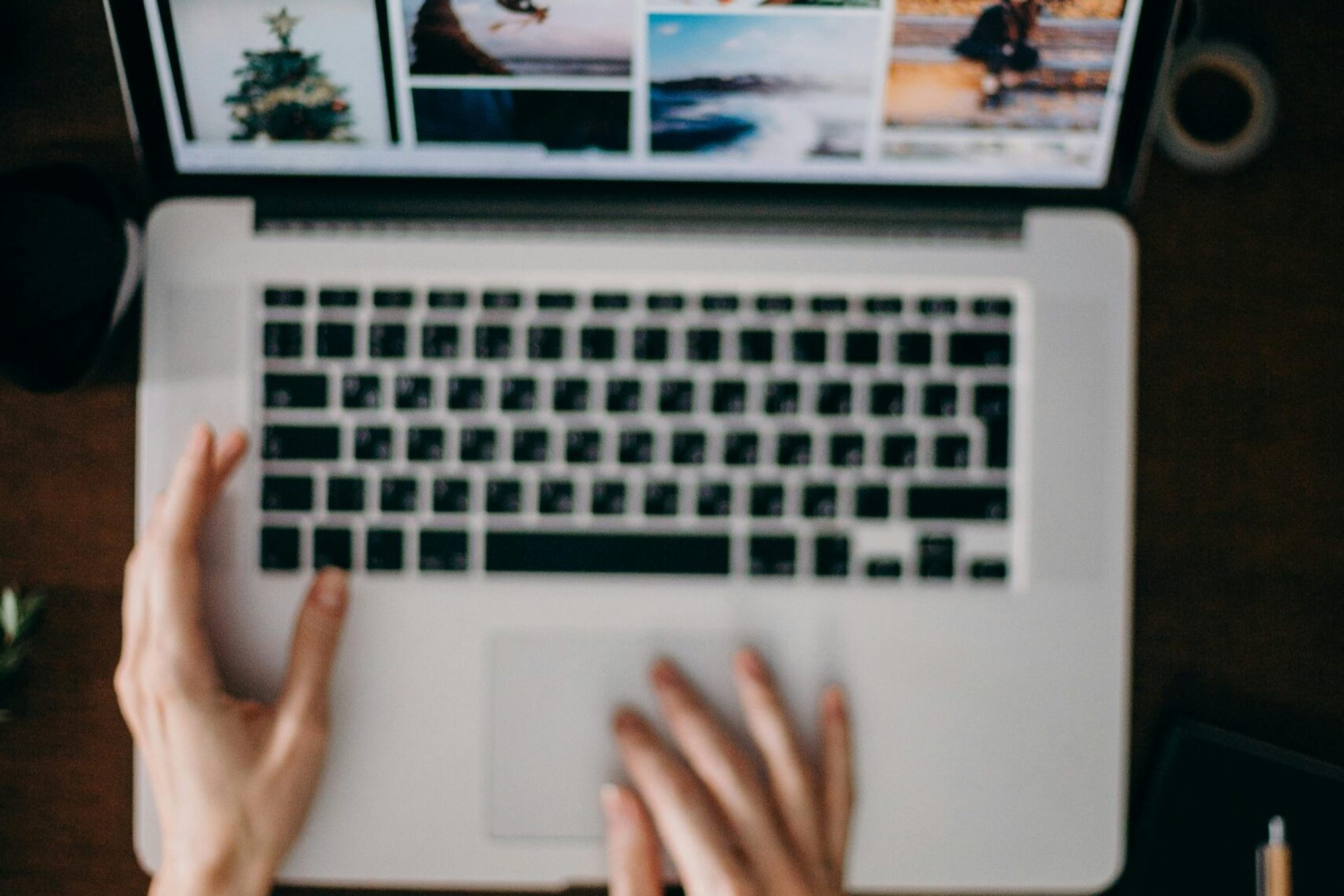 pexels-photo-3584993-3584993-1 Hands using a laptop to browse photo galleries, illustrating digital creativity and remote work.